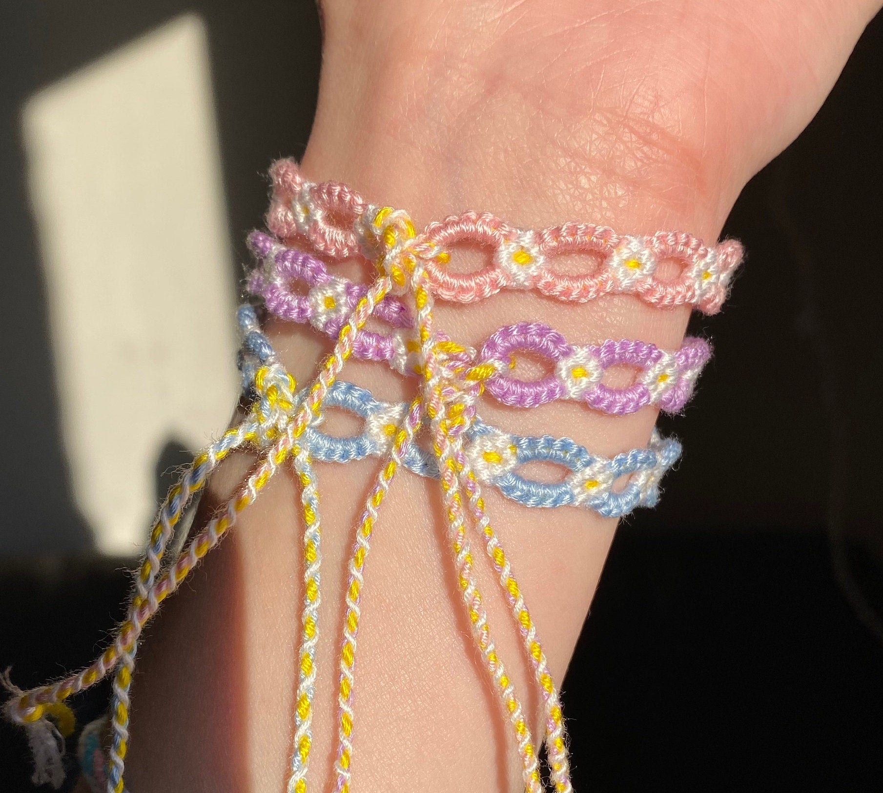 Light pink string bracelet with colourful beads and flowers